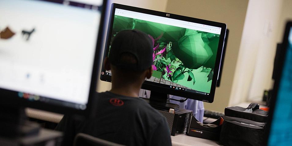 Student designing video games at computer